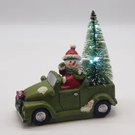 Snowman with his Christmas tree in a Car- Christmas decorations